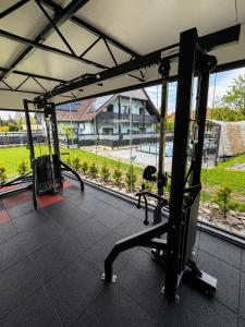 a gym with a large window with a view of a park at Luna Et Sol Apartments in Rząska