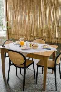 a table with food and orange juice on it at Ritson Hotel in Vlorë
