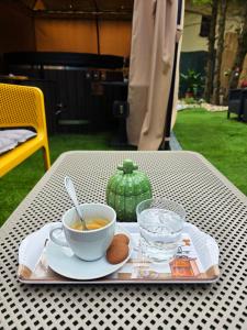 a table with a bowl of soup and a plate of food at Arany Virág Vendégház in Mór