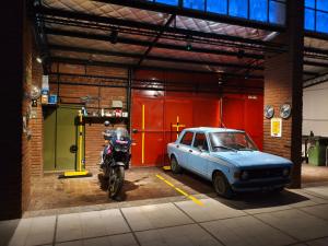 a motorcycle and a car parked in a garage at Complejo las Catalinas Dto 2 A in Puerto Madryn
