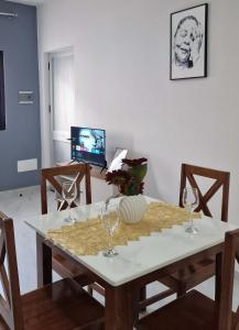 a dining room with a table with wine glasses on it at Kaza Branka in Sal Rei