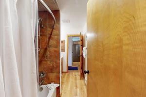 a bathroom with a shower and a toilet next to a door at Marina Place 137 in Dillon +54 photos