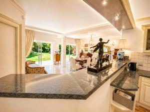 a kitchen and living room with a statue on a counter at Villa Daurus in Vallauris