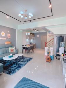a living room with a couch and a table at Happiness blossoms Homestay in Wujie