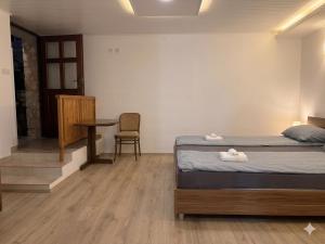 a bedroom with a bed and a table and a chair at Danilo Room 1 in Pula