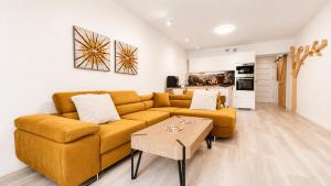 a living room with a couch and a table at CHARZYKOWSKIE TARASY in Charzykowy