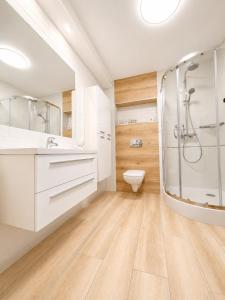 a bathroom with a shower and a toilet at CHARZYKOWSKIE TARASY in Charzykowy +71 photos