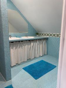 a bathroom with two sinks and a mirror at La cour des hôtes in Fenain +15 photos