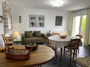 a living room with a table and a couch at La cour des hôtes in Fenain