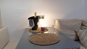 a table with two wine glasses and a candle on it at Duerme en un barco in Moaña +13 photos