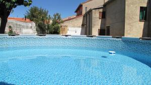 a large blue swimming pool in a house at Villa Conde, Piscina, Barbacoa y Gran Patio in Prado