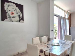 a dining room with a table and a painting on the wall at La Casa di Anastasya in Castiglione Torinese