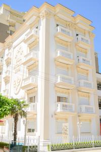 a large white building with white balconies on it at Vila Vitoria in Shëngjin