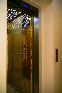 a elevator with a glass door in a building at Vila Vitoria in Shëngjin +27 photos