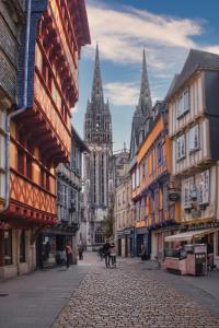 a cobblestone street in a city with tall buildings at Location 2 pers centre historique de quimper in Quimper +1 photo