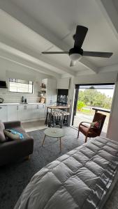 a living room with a bed and a kitchen at Beach view studio 337 in Omapere