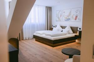 a hotel room with a bed and a table at Johanniter Gästehaus in Münster +115 photos