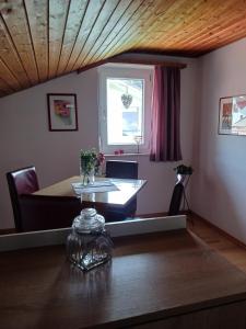 a dining room with a table and a window at Haus Huber in Übersee +6 photos