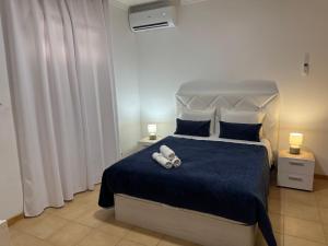 a bedroom with a bed with two towels on it at Alforra Residence 1-T2-centro-praias-Levadas in Câmara de Lobos +73 photos