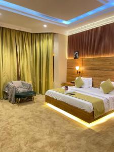 a hotel room with two beds and a chair at Brava Hotel in Ibadan +53 photos