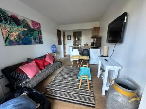a living room with a couch and a table at Casita Bosque-Rucalemu in Valdivia