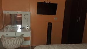 a bedroom with a bed and a television on the wall at Apartamento La Fortuna #2 in Fortuna