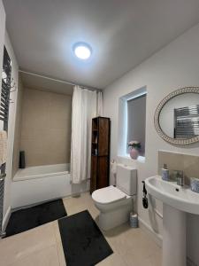 a bathroom with a white toilet and a sink at Modern House in Dublin15, Great Location Near Dublin Airport in Tyrrelstown
