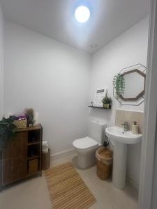 a bathroom with a white toilet and a sink at Modern House in Dublin15, Great Location Near Dublin Airport in Tyrrelstown