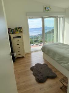 a bedroom with a bed and a large window at Casa Broullón in Moaña