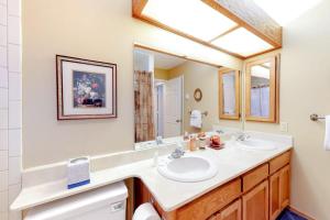 a bathroom with two sinks and a mirror at Silverpick #303 - River Rock Retreat in Durango +44 photos