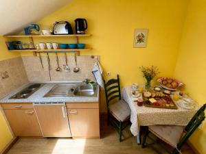 a small kitchen with a table and a sink at Ferienwohnung Bischofshäusl in Berchtesgaden