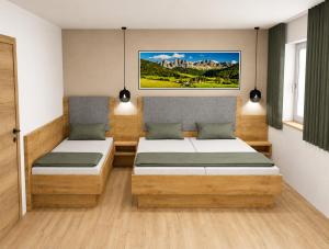 a room with two beds and a painting on the wall at Wolf Apartments in Ladis