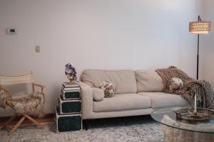 a living room with a couch and a table at Belmont Station in Belmont +28 photos
