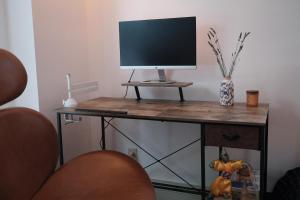 a desk with a computer monitor on top of it at Belmont Station in Belmont