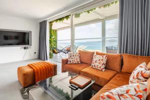 a living room with a couch and a large window at The blue Mirage II in Tangier