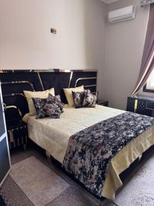 a bedroom with a large bed with pillows on it at Amor Hotel in Fez +47 photos