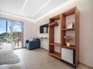 a living room with a bed and a book shelf at Vourtaréa Guesthouse in Himare