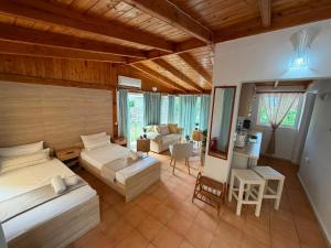 a bedroom with two beds and a living room at KATIA BEACH Holiday Cottage in Kassiopi
