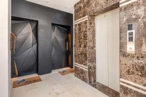 a hallway with a wall of glass doors at The blue Mirage II in Tangier +29 photos