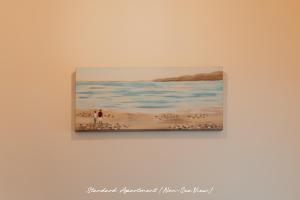 a painting of people on the beach at The Priory House in Tynemouth