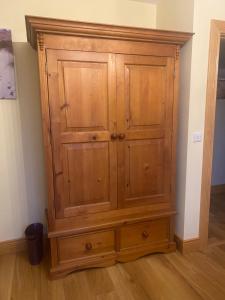 a wooden cabinet in the corner of a room at Hunthill in Tulach an Iarainn +7 photos