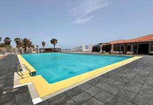a large swimming pool with a yellow curb at tud dret in Santa Maria