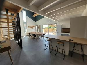 a kitchen and dining room with a long table and chairs at Les écuries in Secondigny