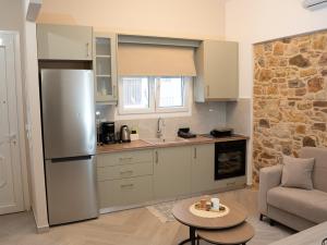 a kitchen with a refrigerator and a table in a room at Meltemi Apartment in Chios