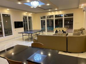 a living room with couches and tables in a room at The Mountain View in Ash Shāghūr