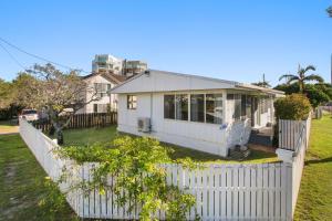 a white house with a white fence at Kitchener Street 2, Golden Beach in Golden Beach +8 photos
