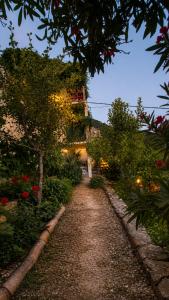 a garden path with a building in the background at Panoramic view with jacuzzi in Vis