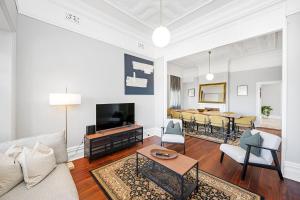 a living room with a couch and a tv at 496 Classic Character Home with Charm in Perth