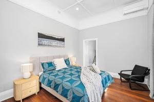 a bedroom with a bed and a chair in it at 496 Classic Character Home with Charm in Perth