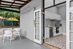 a patio with a table and chairs and a kitchen at 496 Classic Character Home with Charm in Perth